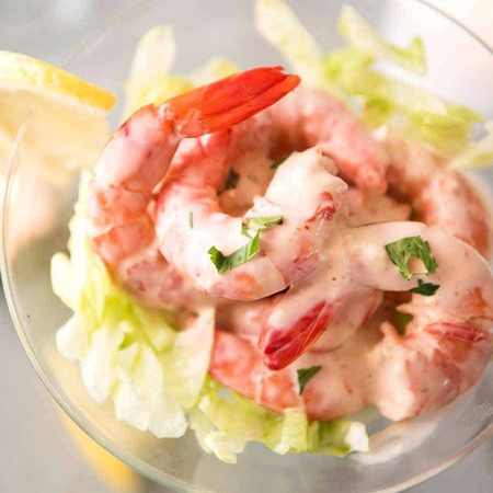 Prawn Cocktails - juicy prawns dressed with Cocktail Sauce on a bed of lettuce served in a martini glass. Elegant appetizer