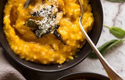 Overhead photo of two black bowls with Creamy Baked Pumpkin Risotto